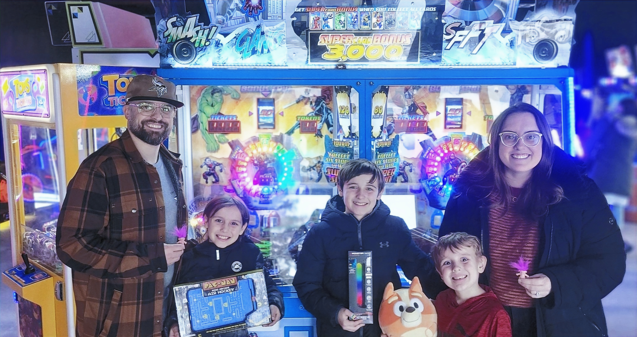 A family celebrates a prize together inside the arcade.