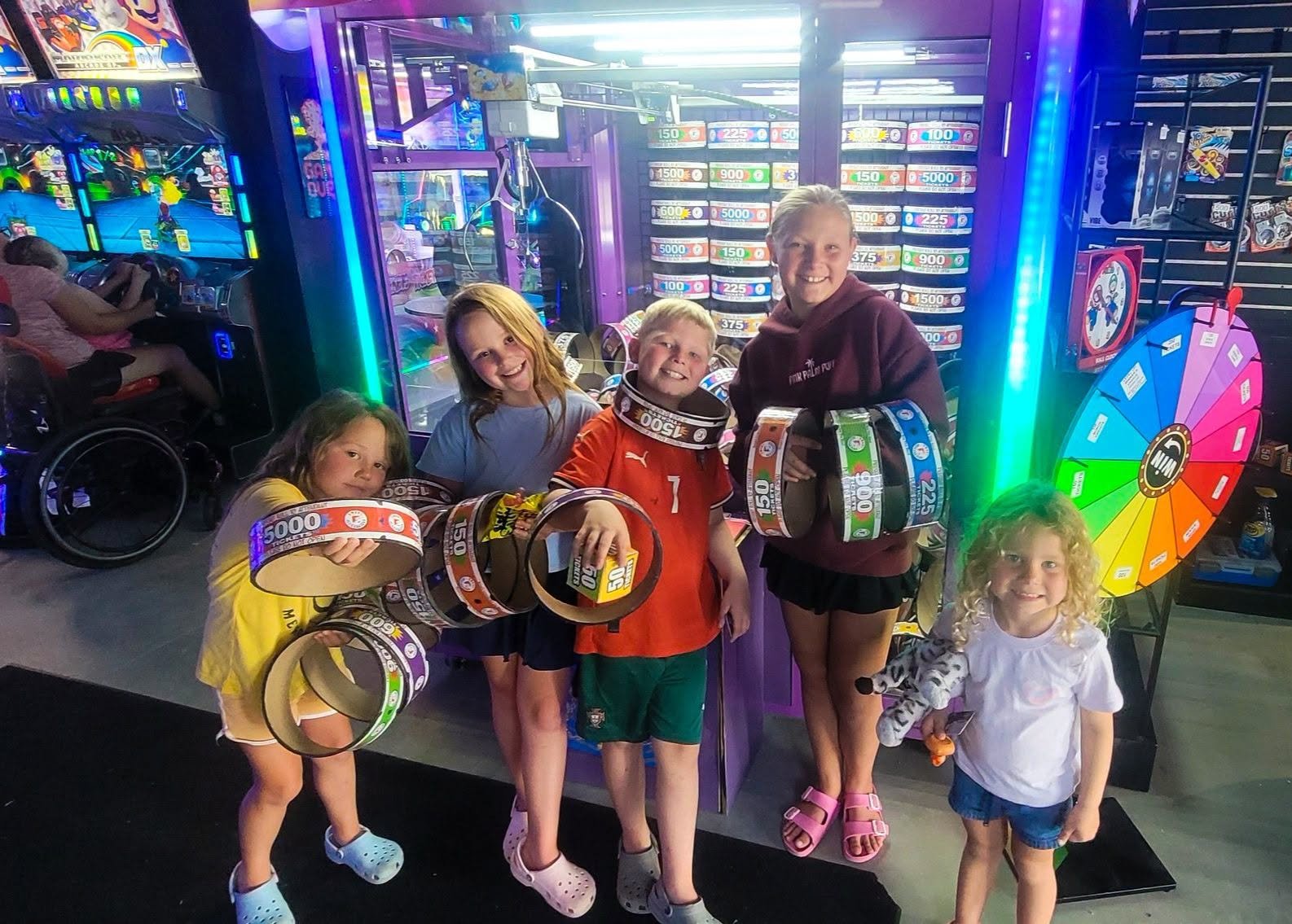 Kids show off armfuls of prize tickets at Level 99 Arcade